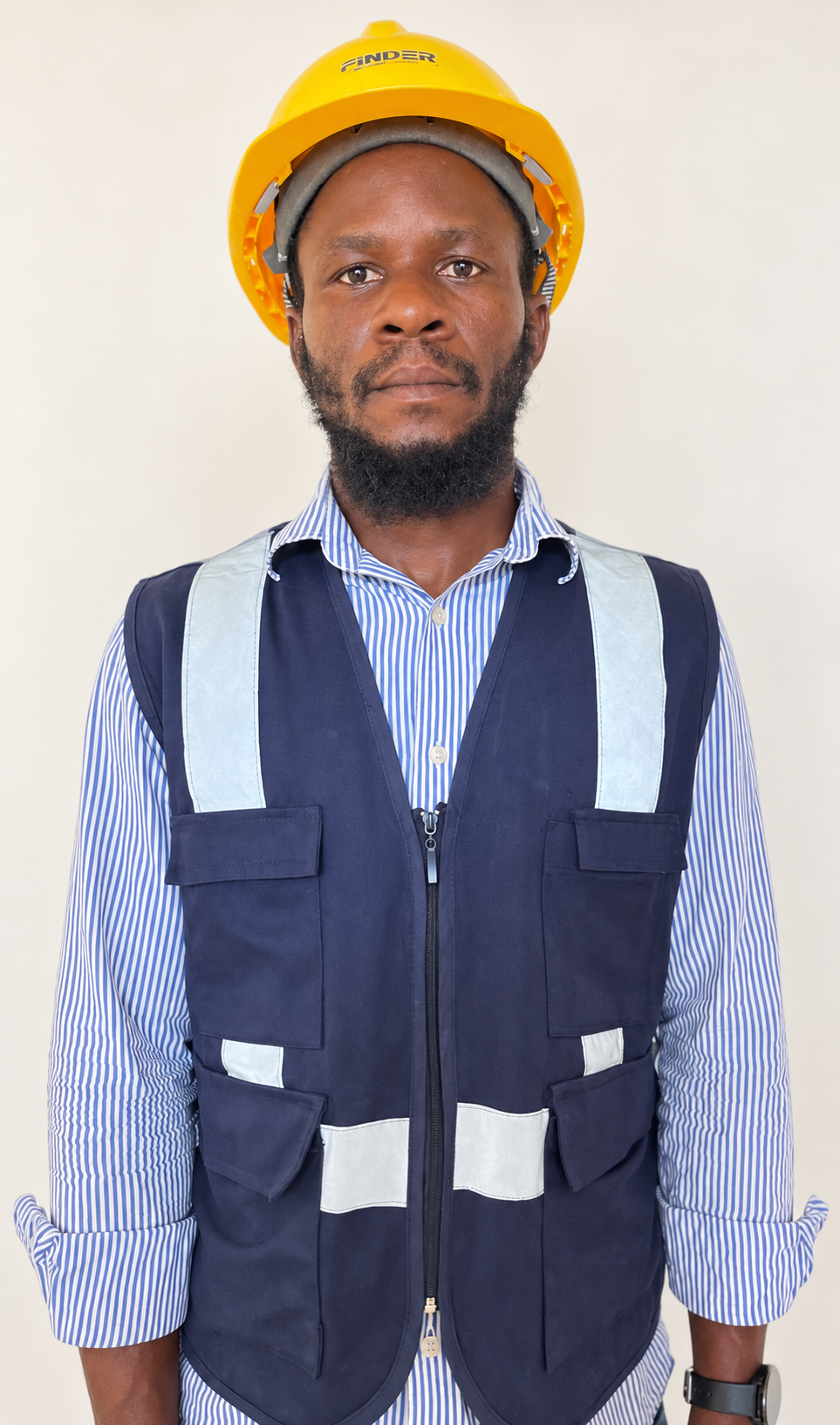 Portrait of Jacob Banjo wearing a yellow hard hat and work vest