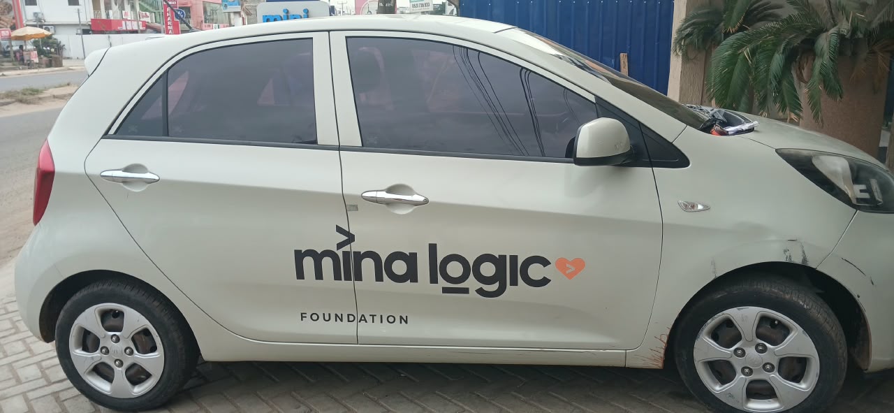 The cream-coloured car with the Mina Logic Foundation wordmark on its doors